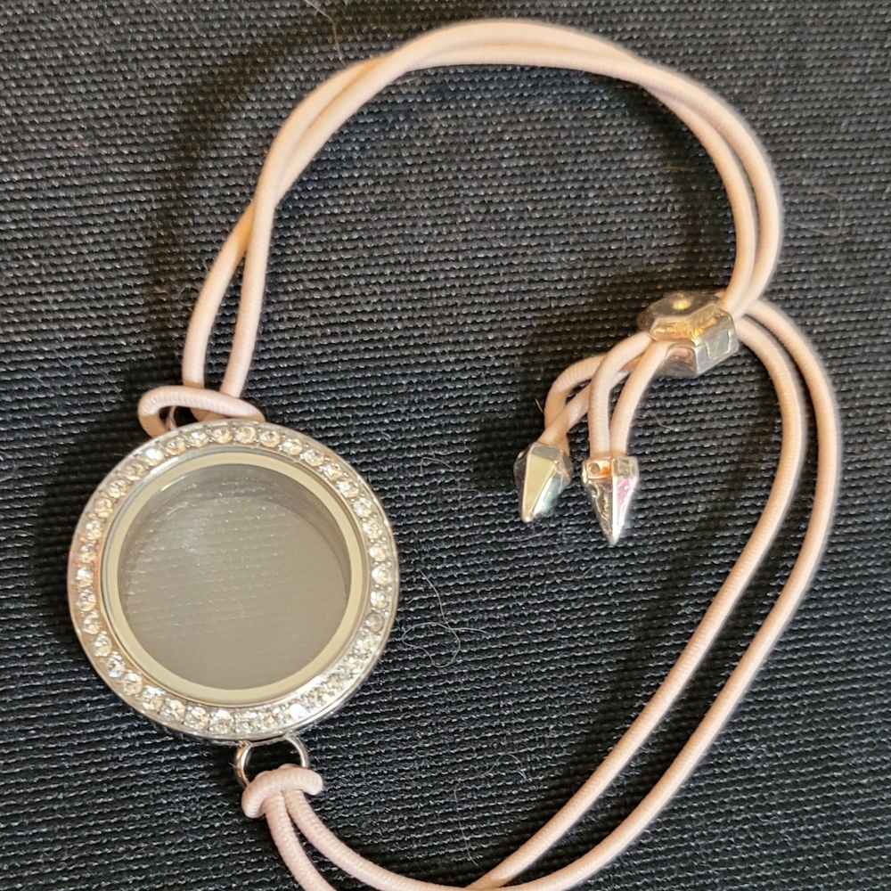 Origami Owl Petite Twist Living Locket on pink stretch bracelet.